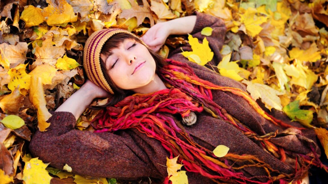 happy woman outside in the leaves